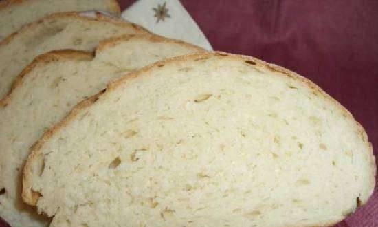 Wheat bread with soft cheese and white wine in the oven