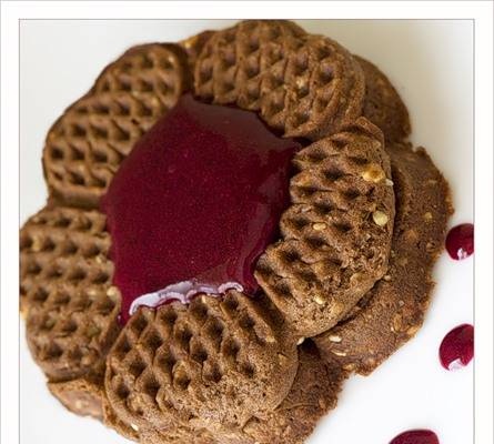 Chocolate waffles with nuts and berry sauce