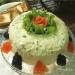 Layered Russian salad with trout and movie caviar.
