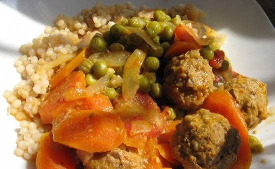 Meatballs with green peas and carrots in a slow cooker