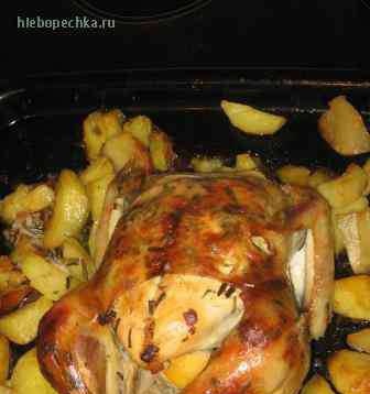 Chicken stuffed with lemons, baked with potatoes and celery