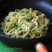 Potato spaghetti with green peas and pesto sauce