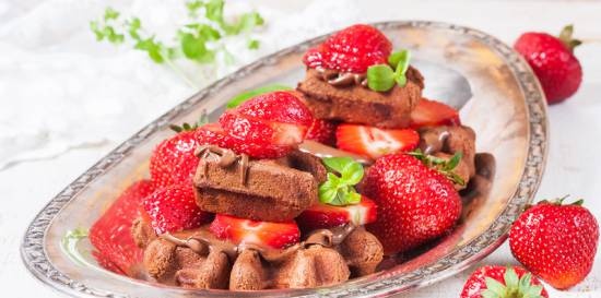 Chocolate waffles with nutella and strawberries