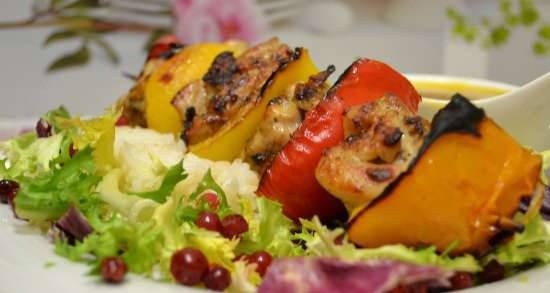 Chicken kebabs with vegetables, tangerine sauce baked in a dome grill
