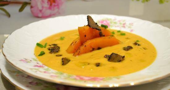 Baked butternut squash puree soup with coconut milk and truffle slices