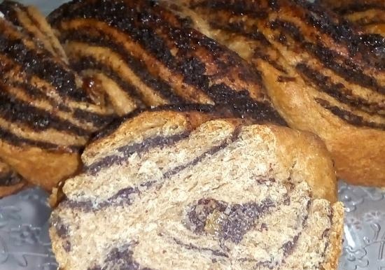 Braid with poppy seeds and raisins made from 100% whole grain yeast dough with soda water
