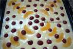 Mineral water pie with cherries and oranges