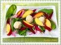 Salad with spinach, nectarines, beetroot and cheese-nut balls, breaded with oat bran