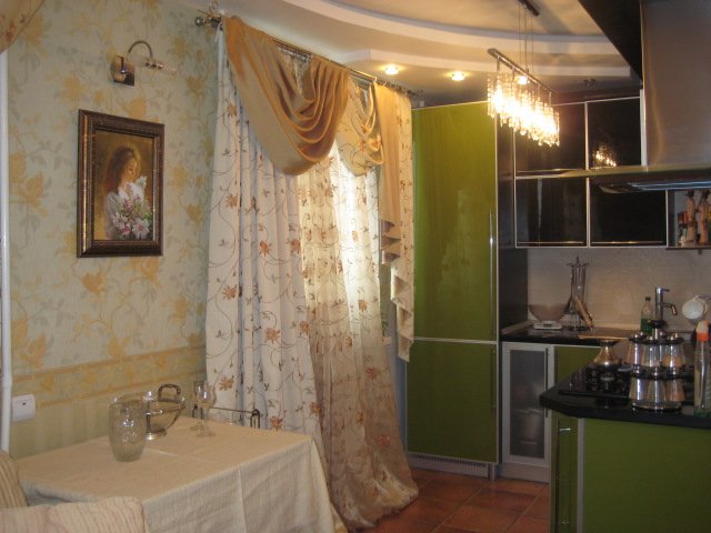 Maniac's dream. Kitchen in light green and orange colors.