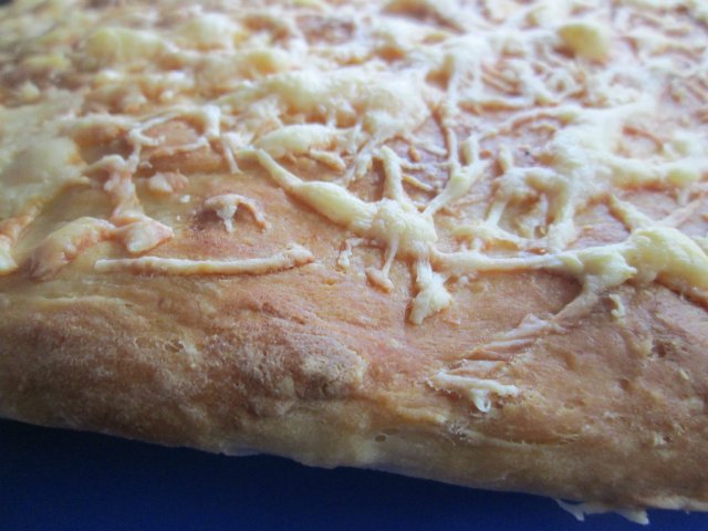 Potato focaccia with cheese and baked garlic