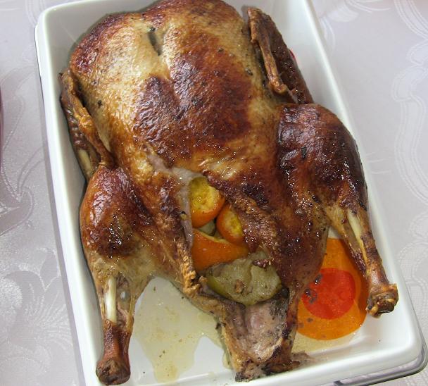 Homemade duck with oranges and apples in orange-wine sauce