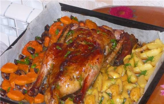 Homemade duck with oranges and apples in orange-wine sauce