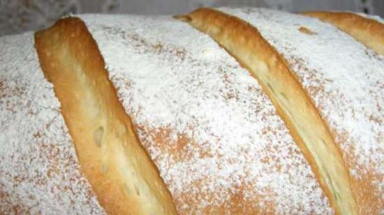 Wheat bread with soft cheese and white wine in the oven