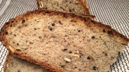 Zuurdesem tarwebrood uit de oven met zaden, volkoren granen en speltmeel