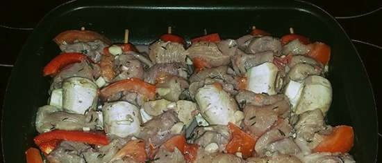 Chicken fillet skewers with vegetables in red wine, baked in the oven