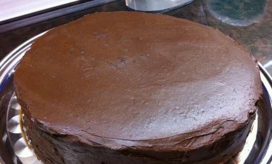 Chocolate-covered prune cake on a biscuit