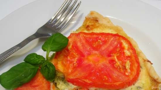 Shortcrust tart with curd and cheese filling, tomatoes and basil