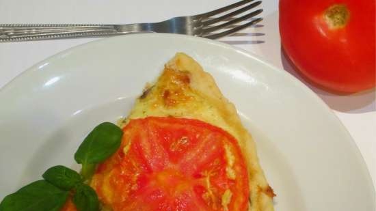 Shortcrust tart with curd and cheese filling, tomatoes and basil