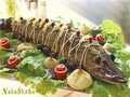 Stuffed pike in grape leaves