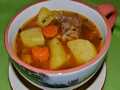 Veal brisket with vegetables, stewed in a slow cooker