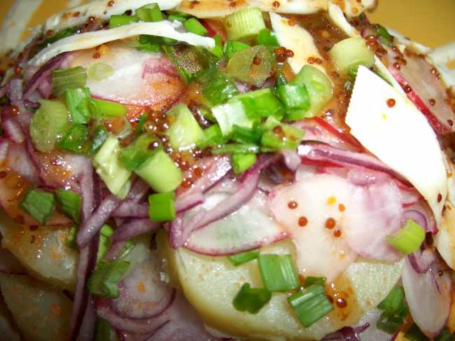 Potato salad with radish, cheese, red flounder caviar